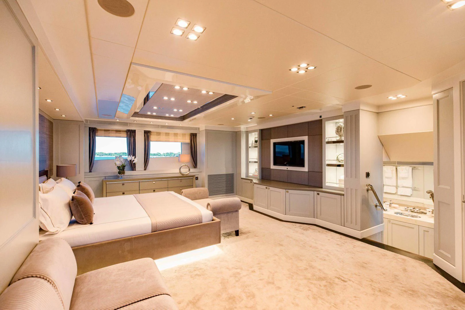 a living room with a couch and a tv aboard TAYRONA Yacht for Sale