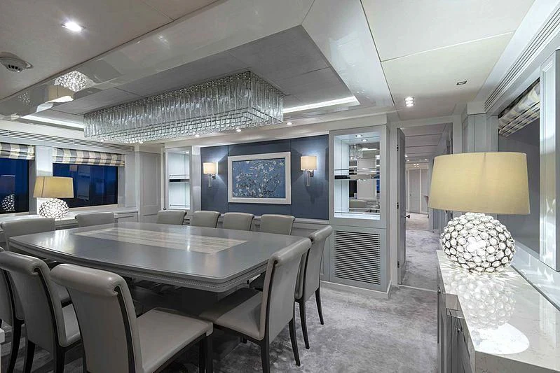 a large dining room with a large table and chairs aboard TAYRONA Yacht for Sale