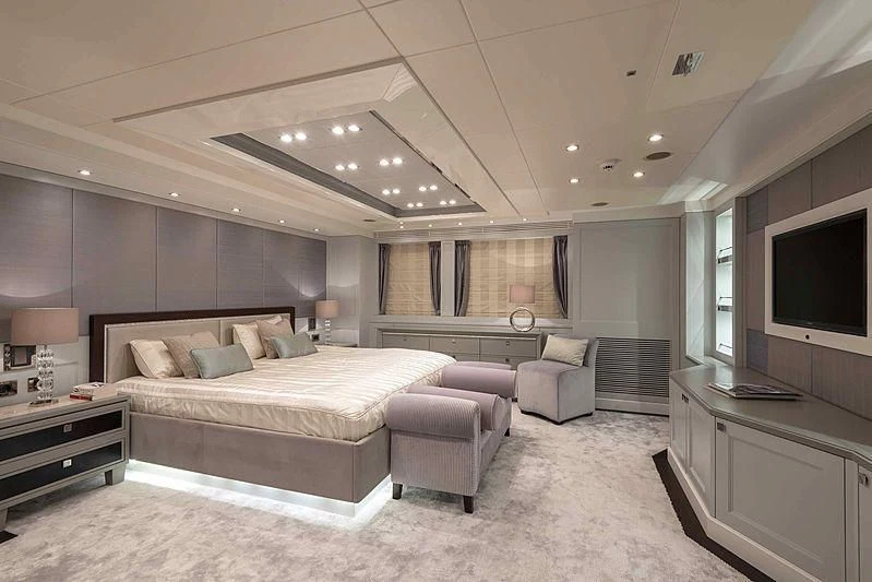 a large bedroom with a large bed aboard TAYRONA Yacht for Sale