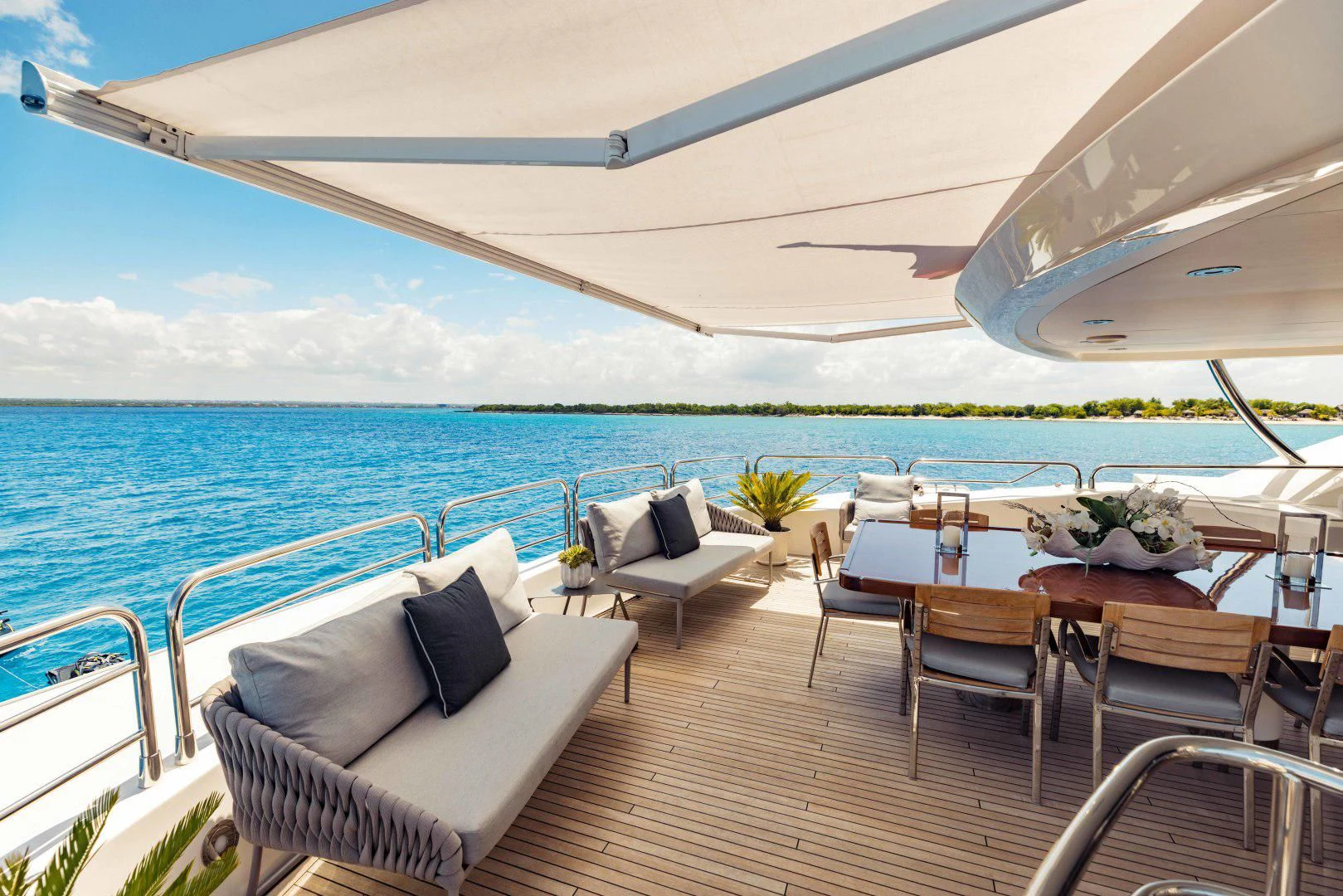 a patio with a table and chairs on it aboard TAYRONA Yacht for Sale