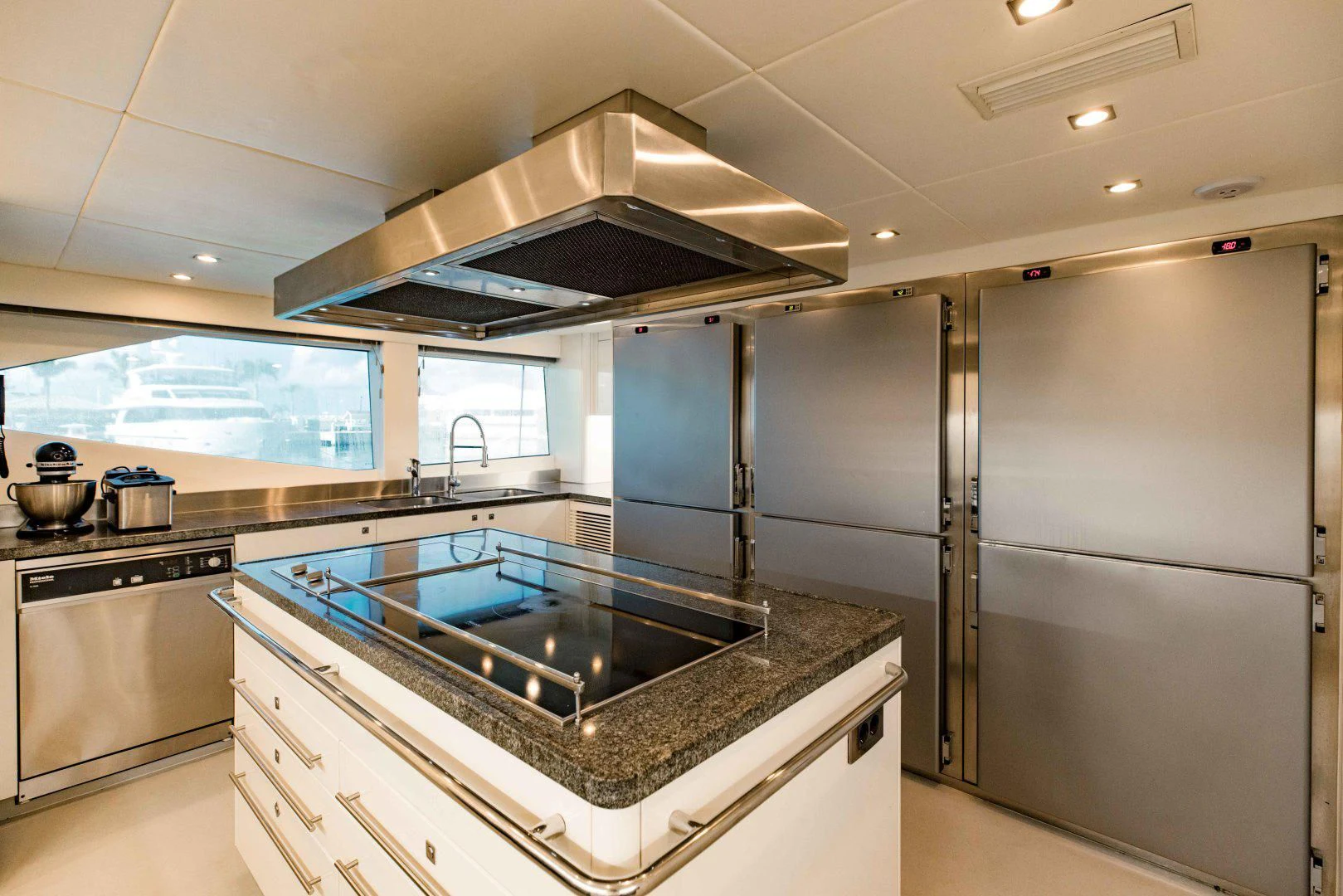 a kitchen with a stove and a refrigerator aboard TAYRONA Yacht for Sale