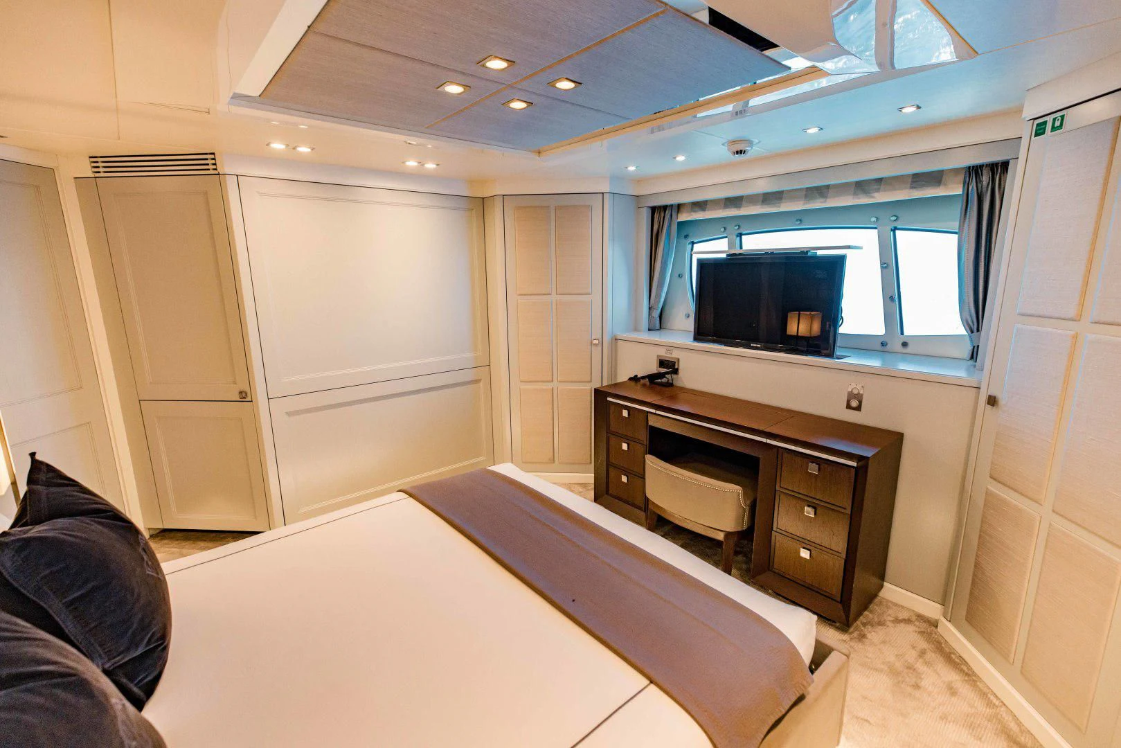 a room with a tv and a dresser aboard TAYRONA Yacht for Sale