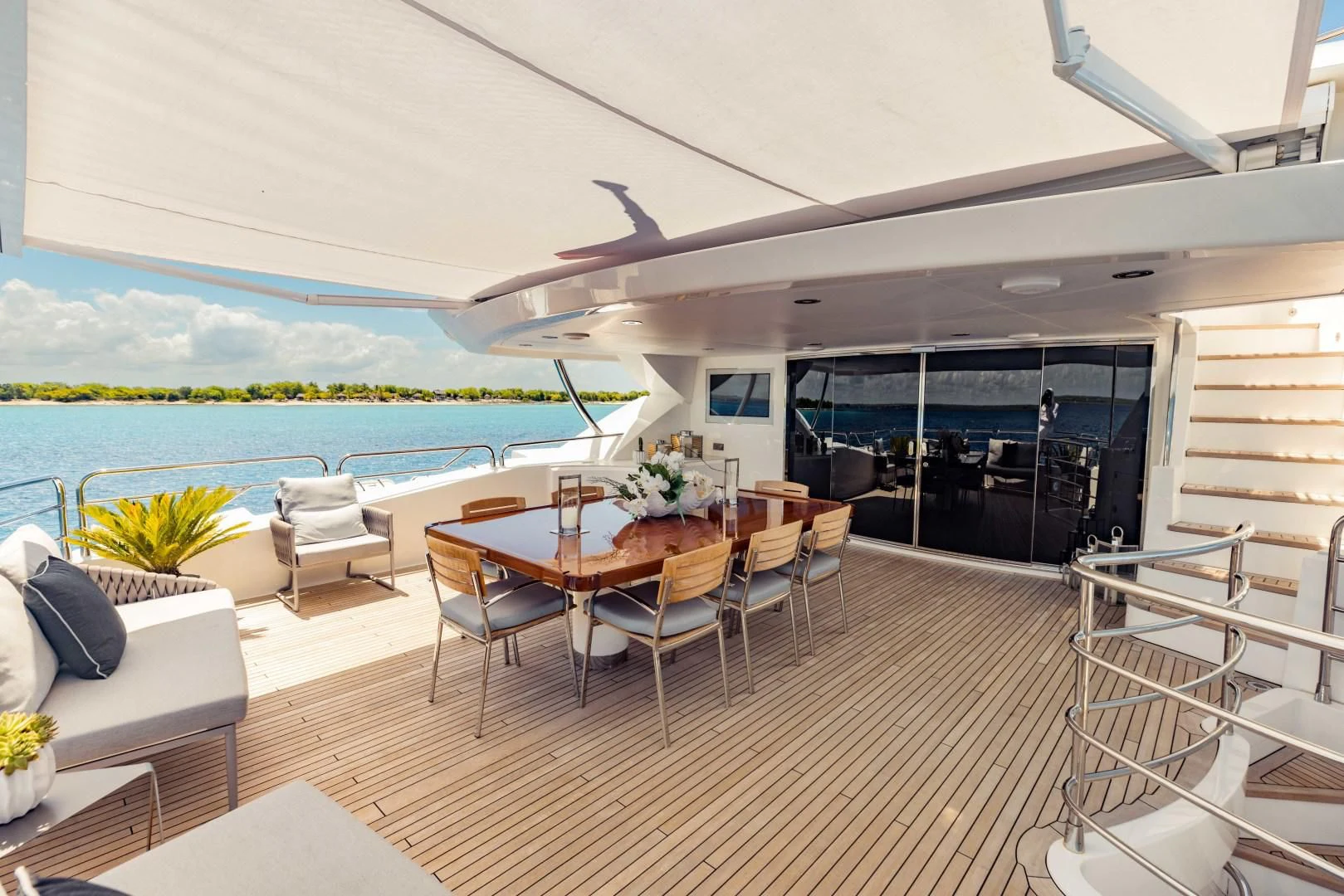 a room with a table chairs and a large pool aboard TAYRONA Yacht for Sale