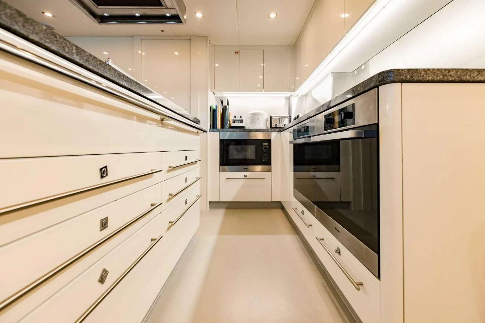 a kitchen with white cabinets aboard TAYRONA Yacht for Sale
