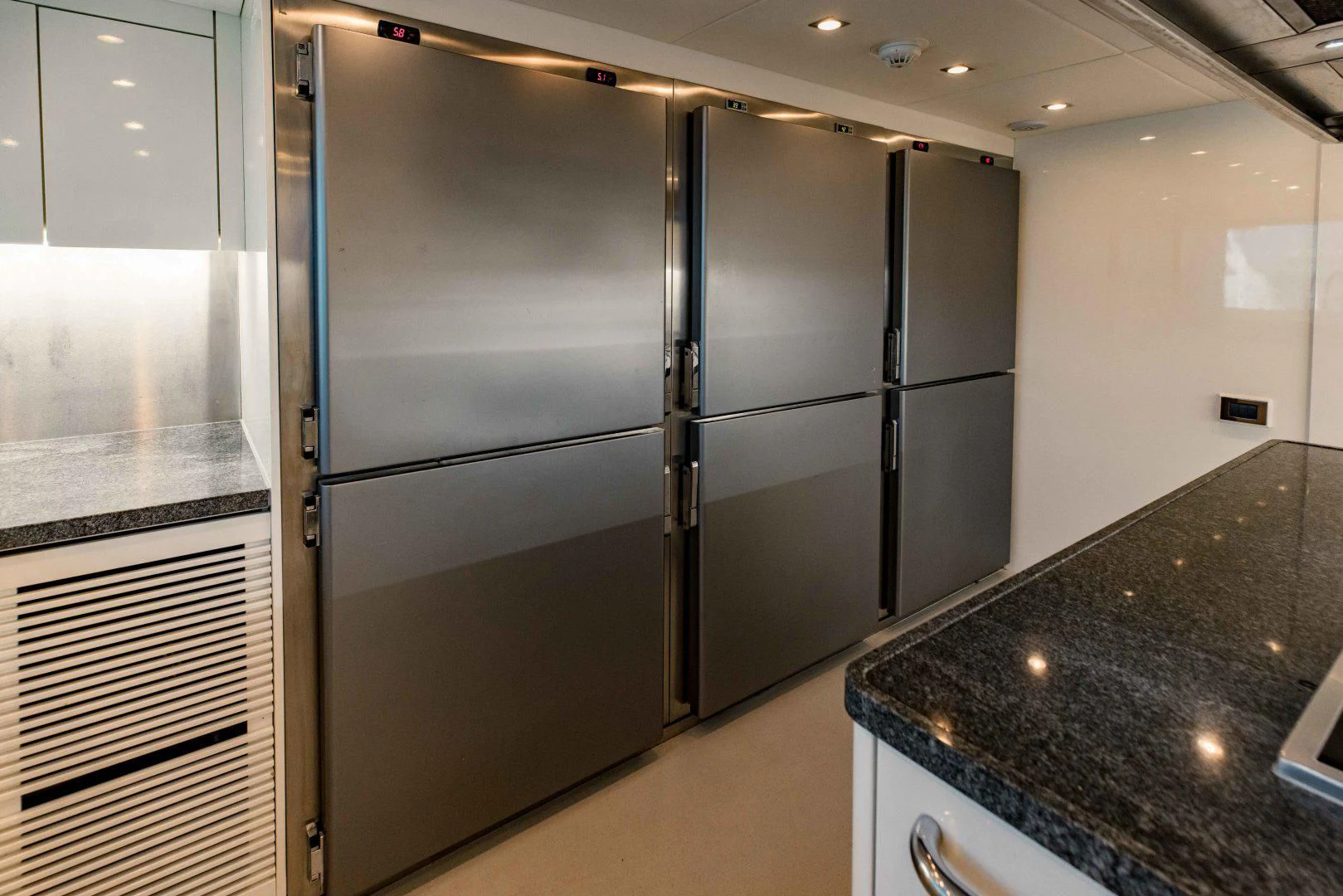 a large kitchen with stainless steel appliances aboard TAYRONA Yacht for Sale