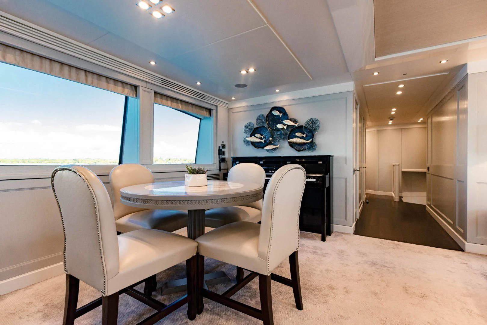 a room with a table and chairs aboard TAYRONA Yacht for Sale