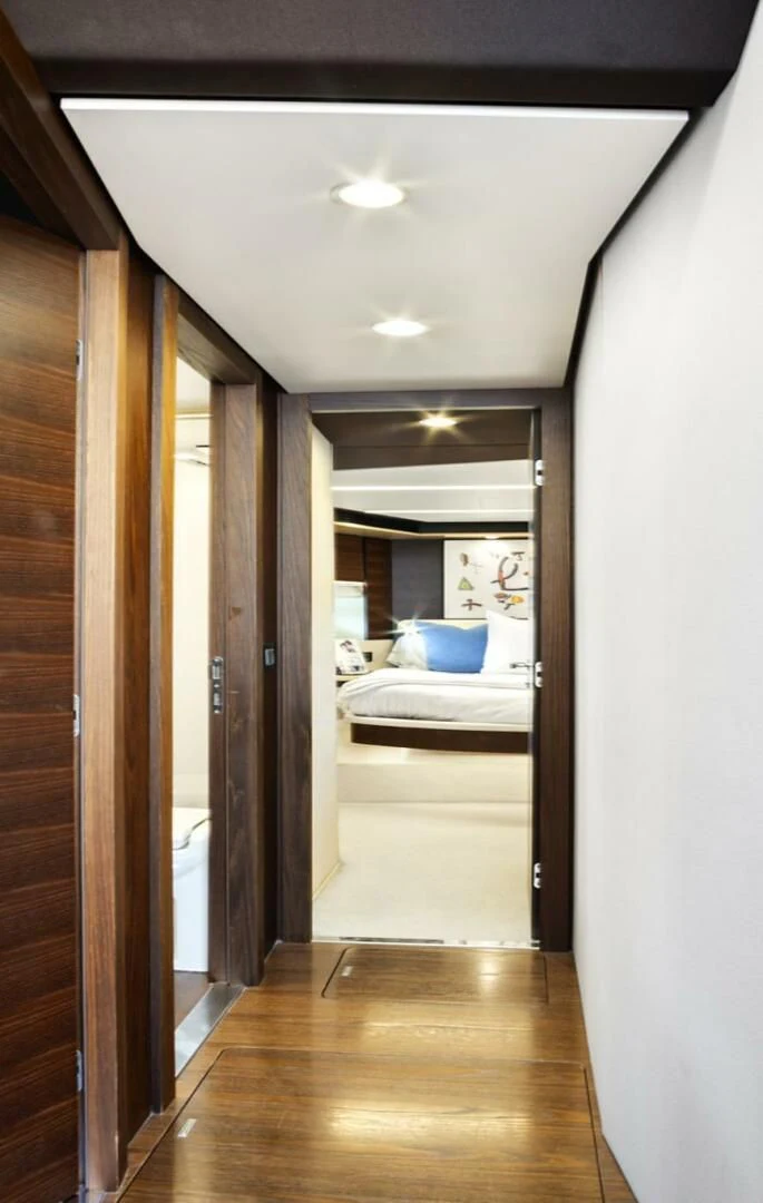 a bedroom with a wood floor aboard GRATITUDE Yacht for Sale