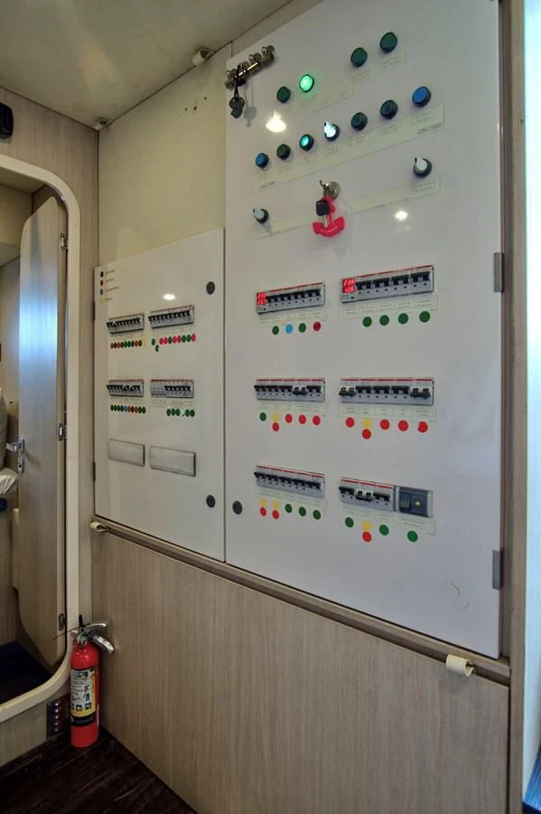 a wall with pictures and magnets aboard GRATITUDE Yacht for Sale