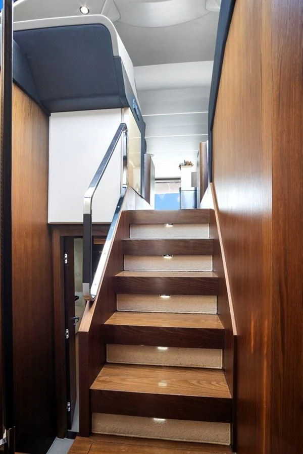 a wooden staircase with a glass door aboard GRATITUDE Yacht for Sale