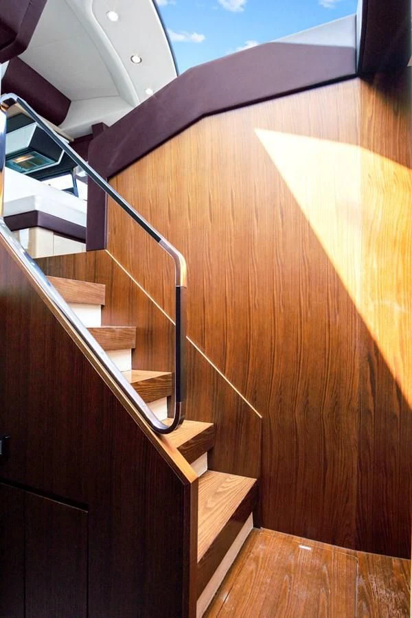 a wooden staircase with a wood railing aboard GRATITUDE Yacht for Sale
