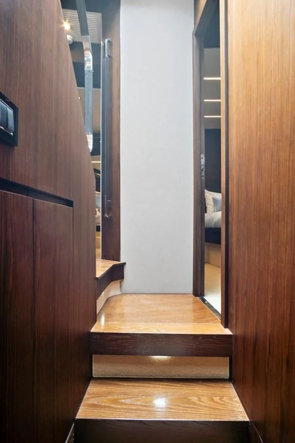 a wooden staircase in a room aboard GRATITUDE Yacht for Sale
