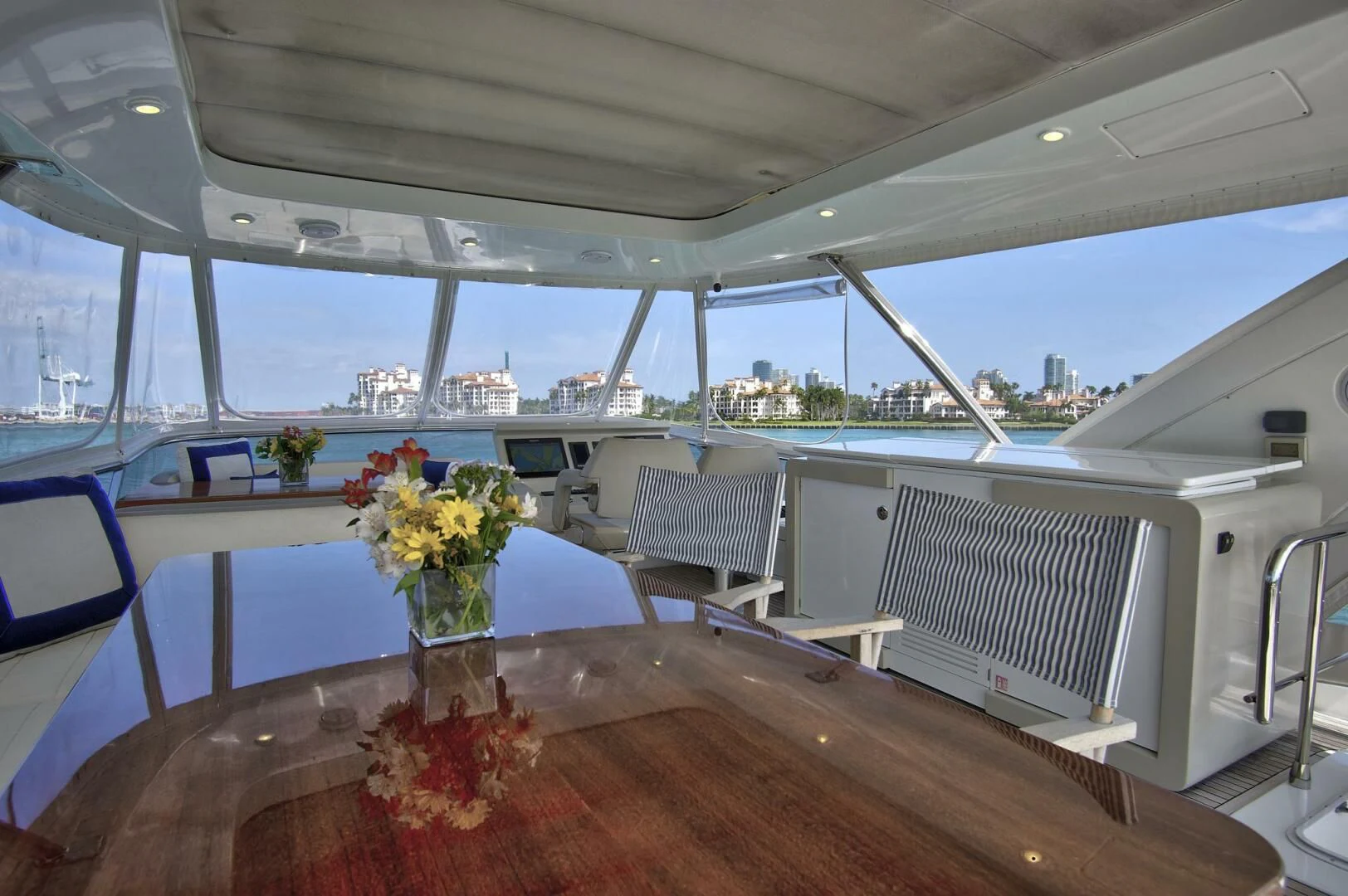 a table with flowers in a glass case on a boat aboard GRATITUDE Yacht for Sale