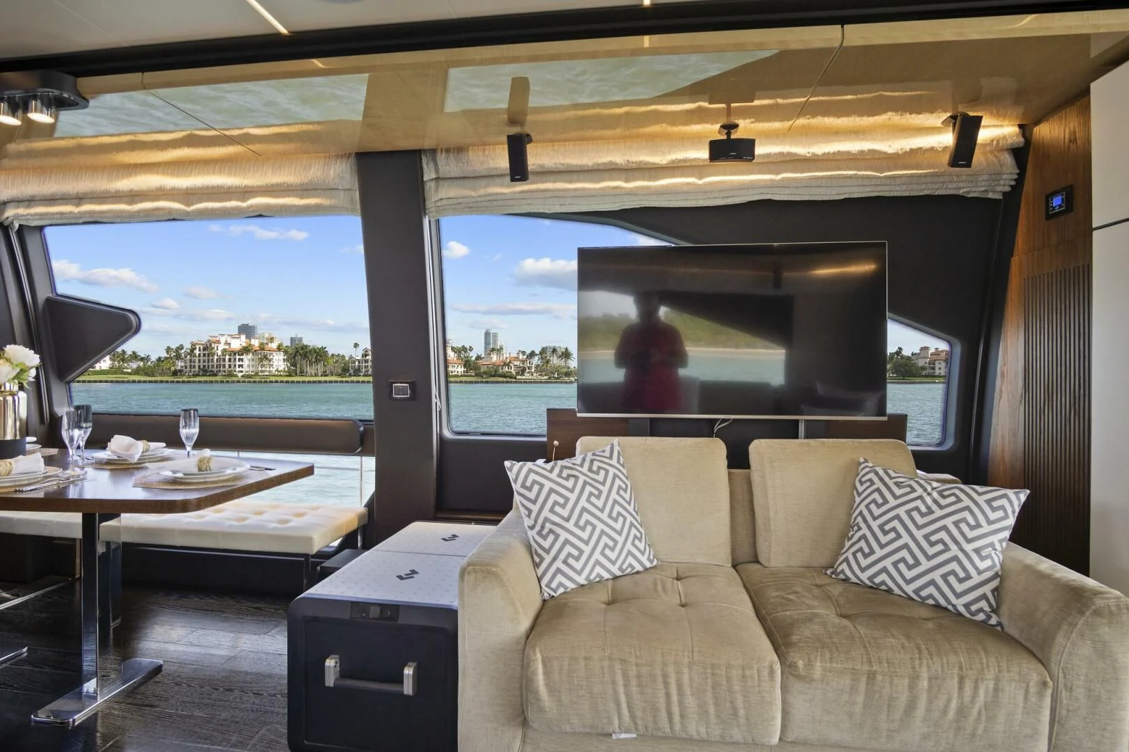 a room with a couch and a table and a view of the water aboard GRATITUDE Yacht for Sale