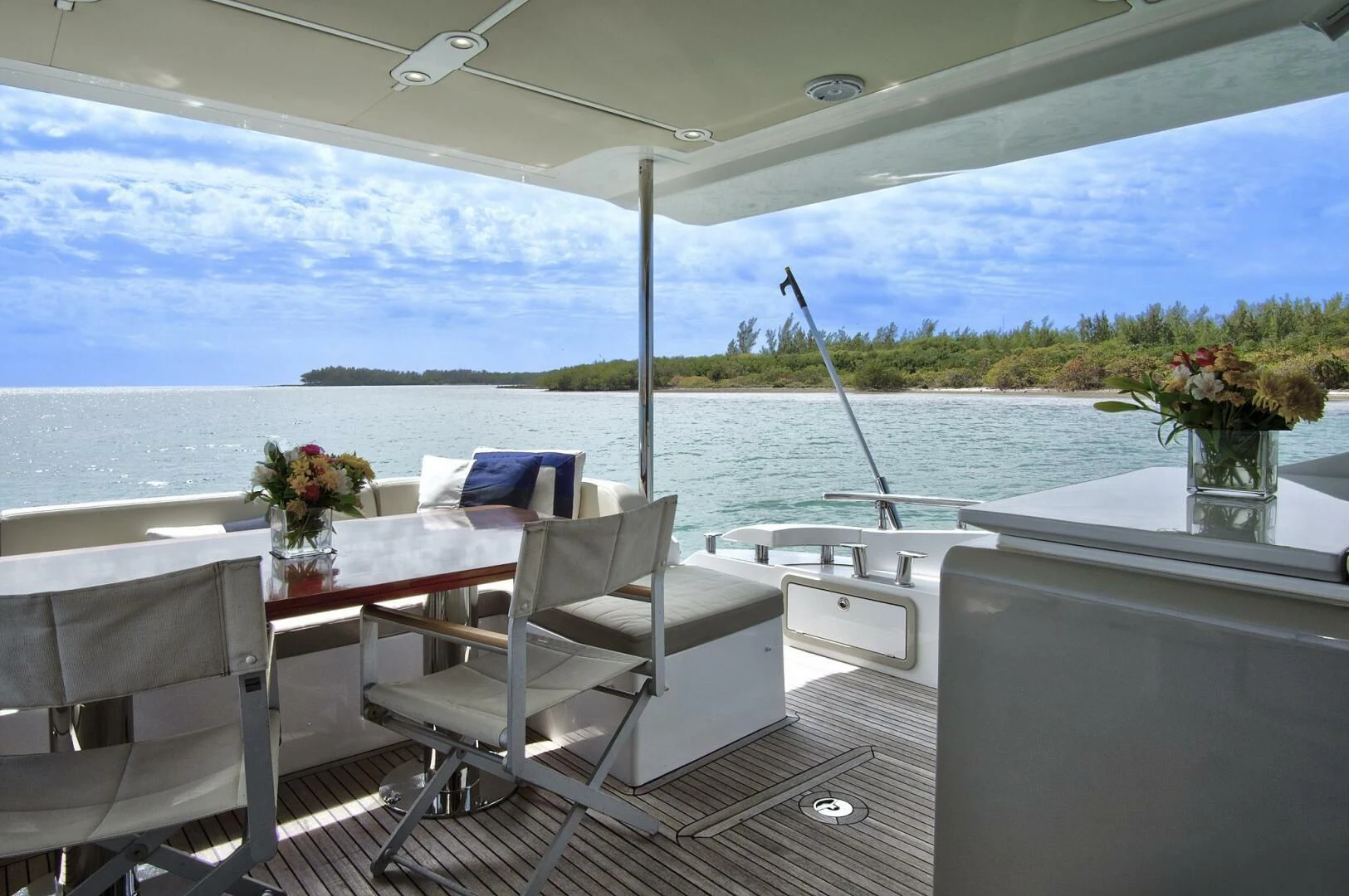 a room with a table chairs and a view of the water aboard GRATITUDE Yacht for Sale