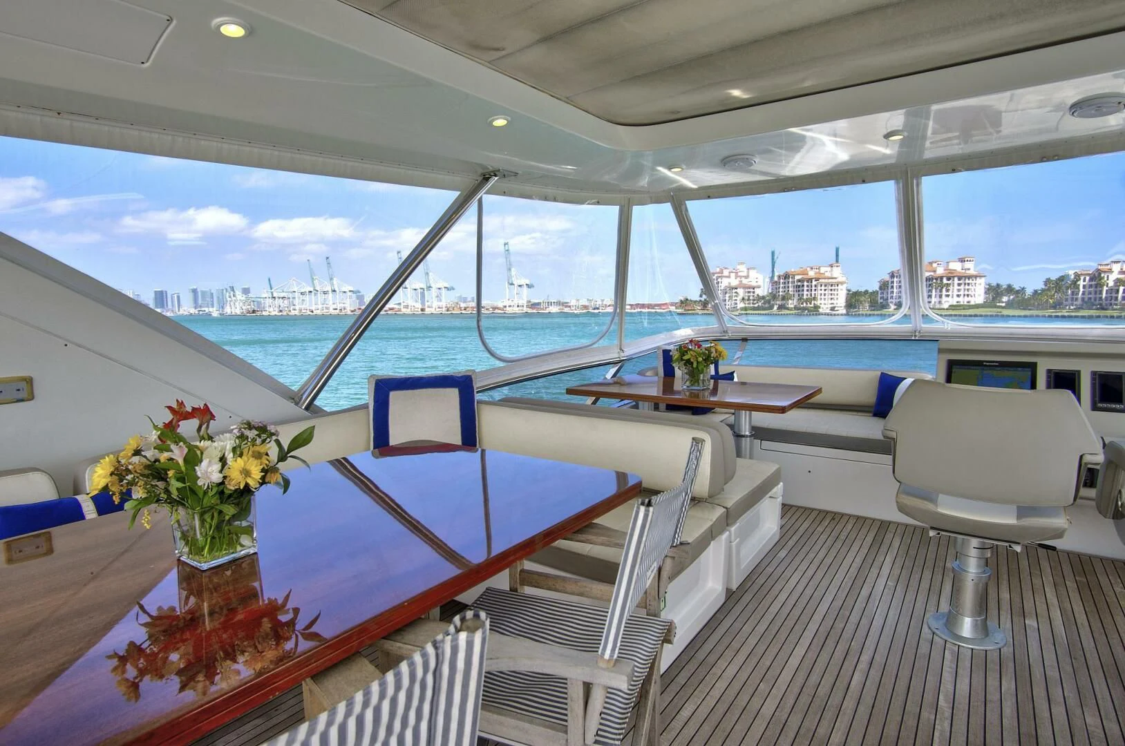 a room with a table chairs and a plant on the table aboard GRATITUDE Yacht for Sale