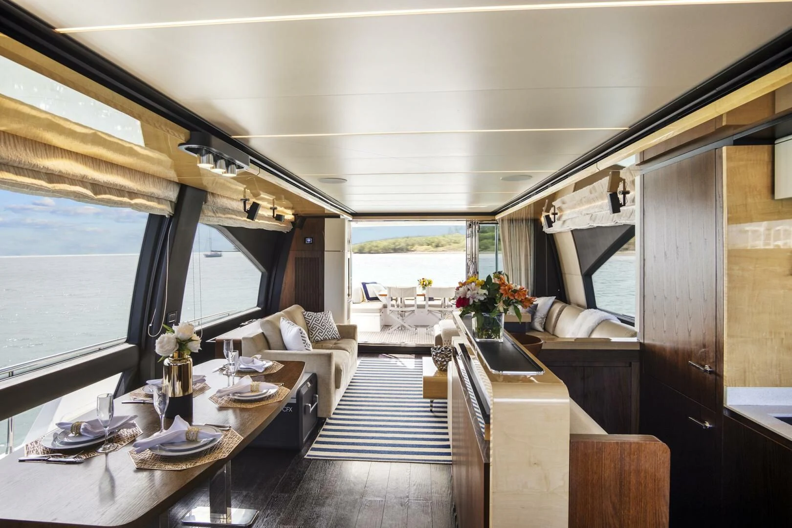 a room with a table chairs and a couch aboard GRATITUDE Yacht for Sale