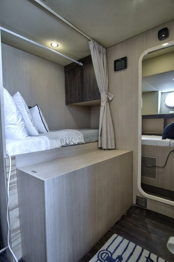 a room with a bed and a mirror aboard GRATITUDE Yacht for Sale