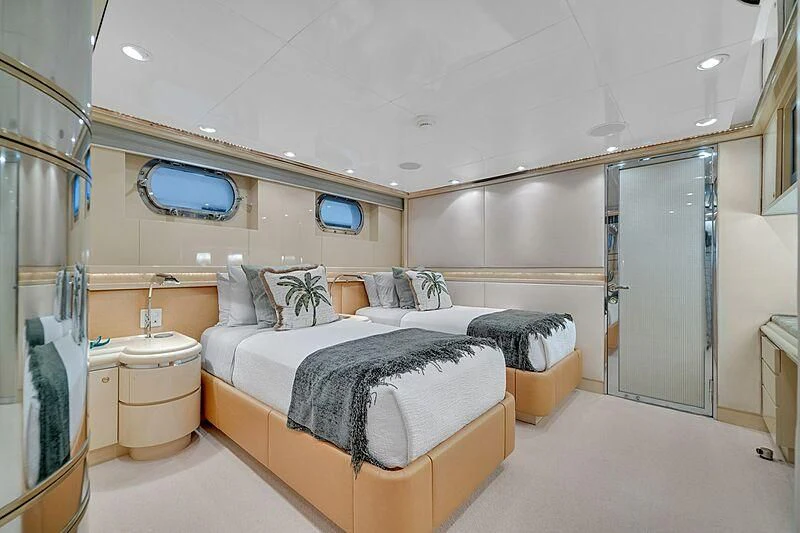 a bedroom with a bed and a mirror aboard MAVERICK Yacht for Charter