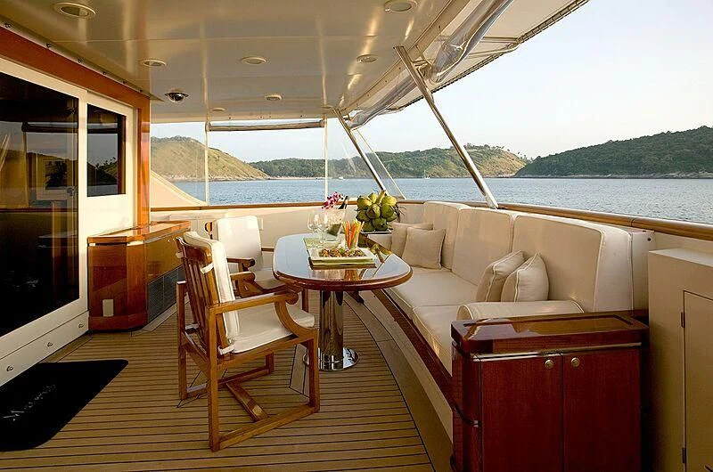 a boat with a table and chairs aboard MAVERICK Yacht for Charter