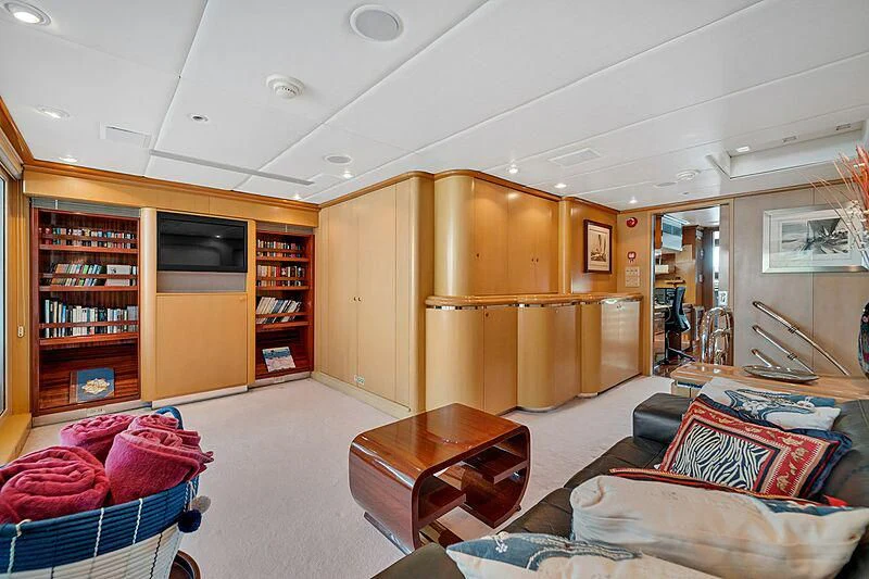 a living room with a bookcase aboard MAVERICK Yacht for Charter