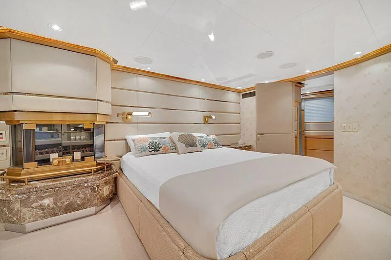 a bedroom with a bed and a fireplace aboard MAVERICK Yacht for Charter