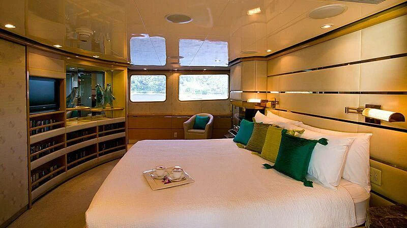 a bed with a white bed spread aboard MAVERICK Yacht for Charter