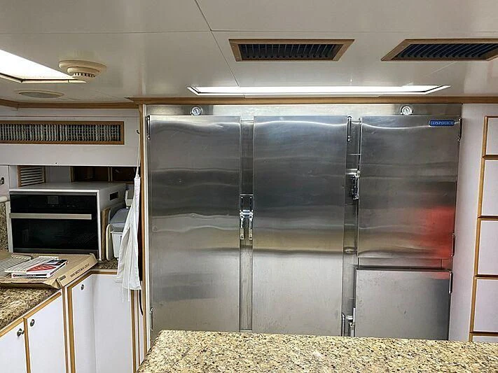 a large black cabinet in a kitchen aboard MAVERICK Yacht for Charter