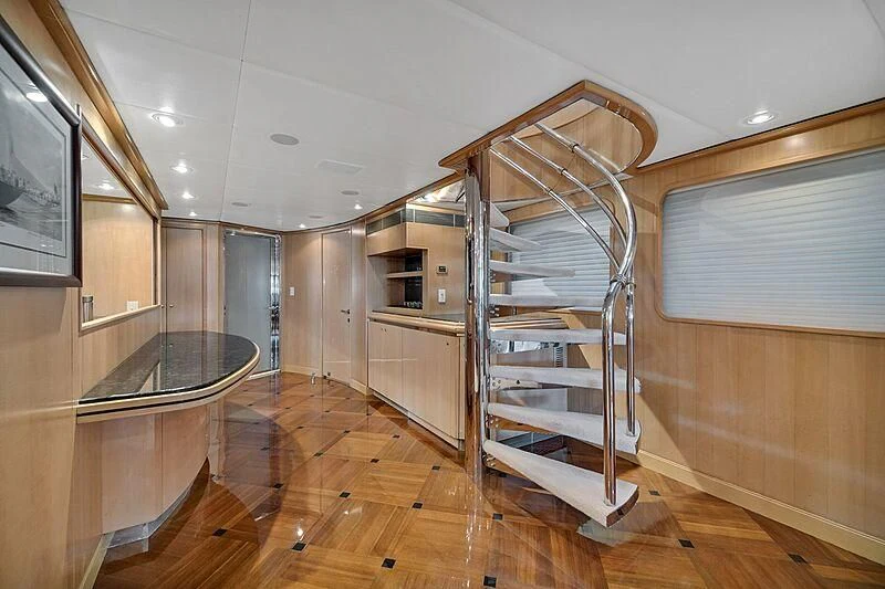 a room with a ladder and a glass table aboard MAVERICK Yacht for Charter
