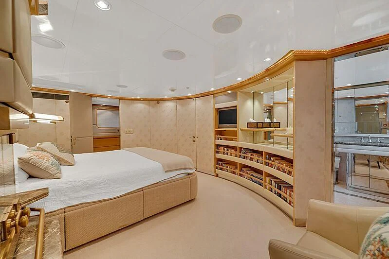 a room with a bed and a bookcase aboard MAVERICK Yacht for Charter