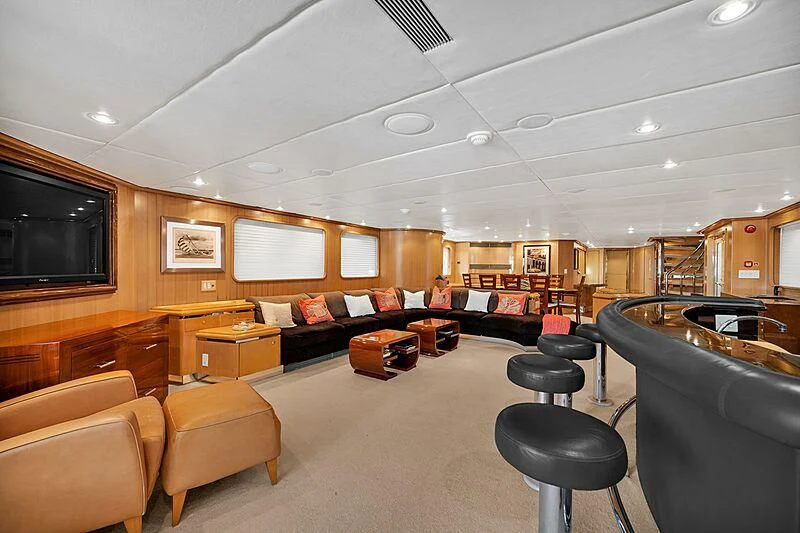 a living room with a large screen aboard MAVERICK Yacht for Charter