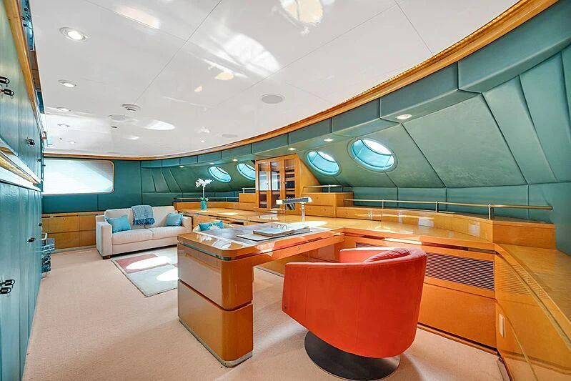 an empty office with a red chair aboard MAVERICK Yacht for Charter