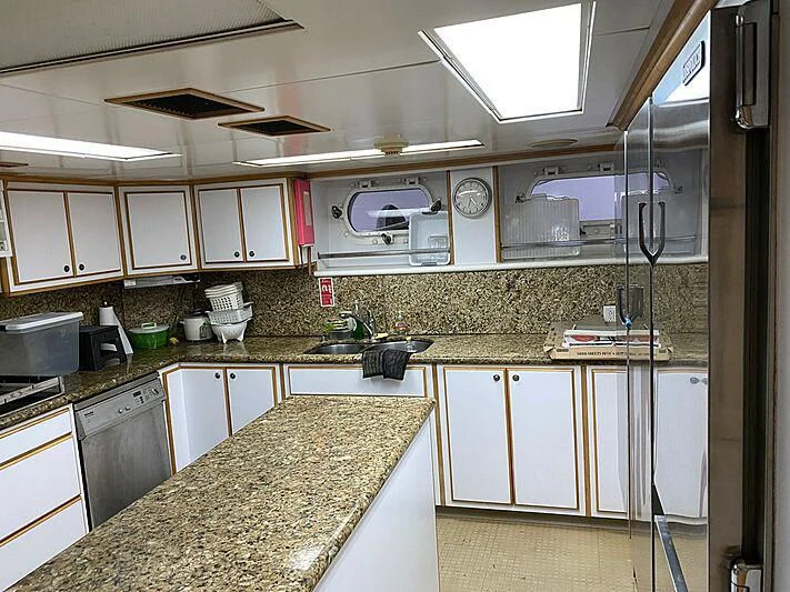 a kitchen with white cabinets aboard MAVERICK Yacht for Charter