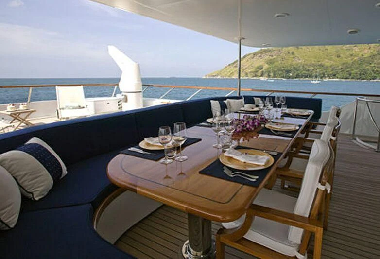 a table with wine glasses on it aboard MAVERICK Yacht for Charter