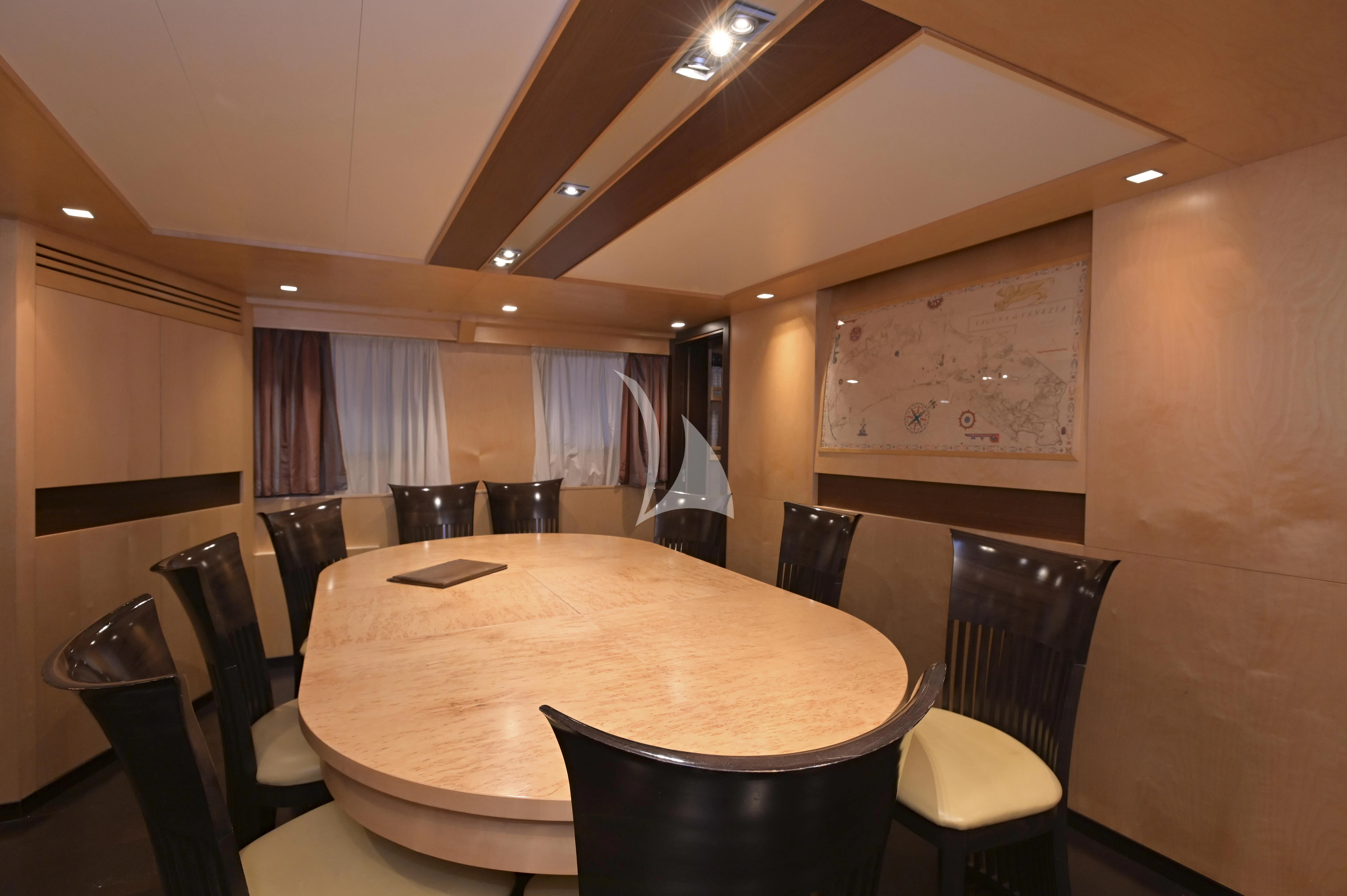 a table with chairs and a curtain aboard LA VOGLIA MATTA Yacht for Charter