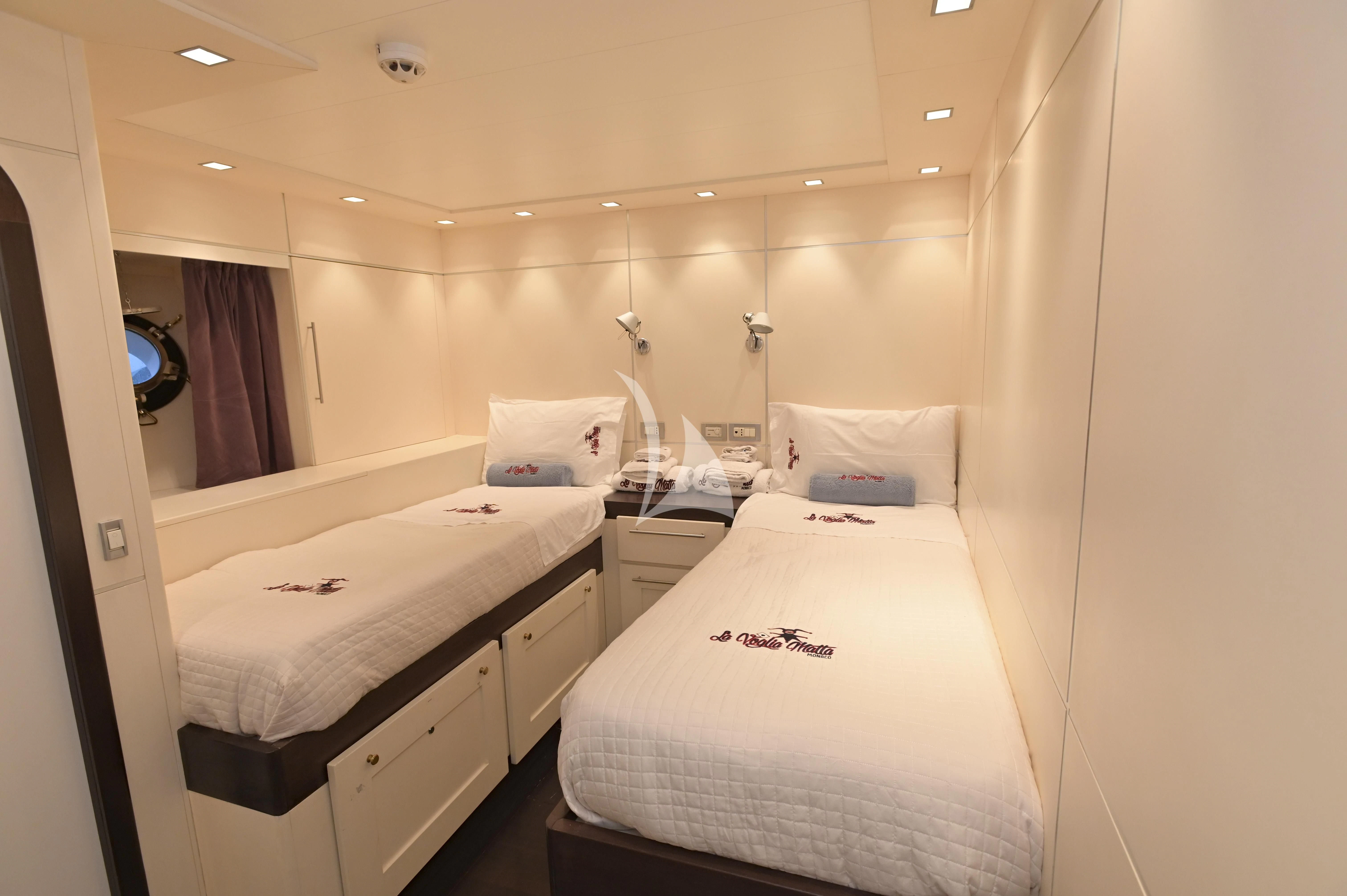 a couple of beds in a hotel room aboard LA VOGLIA MATTA Yacht for Charter