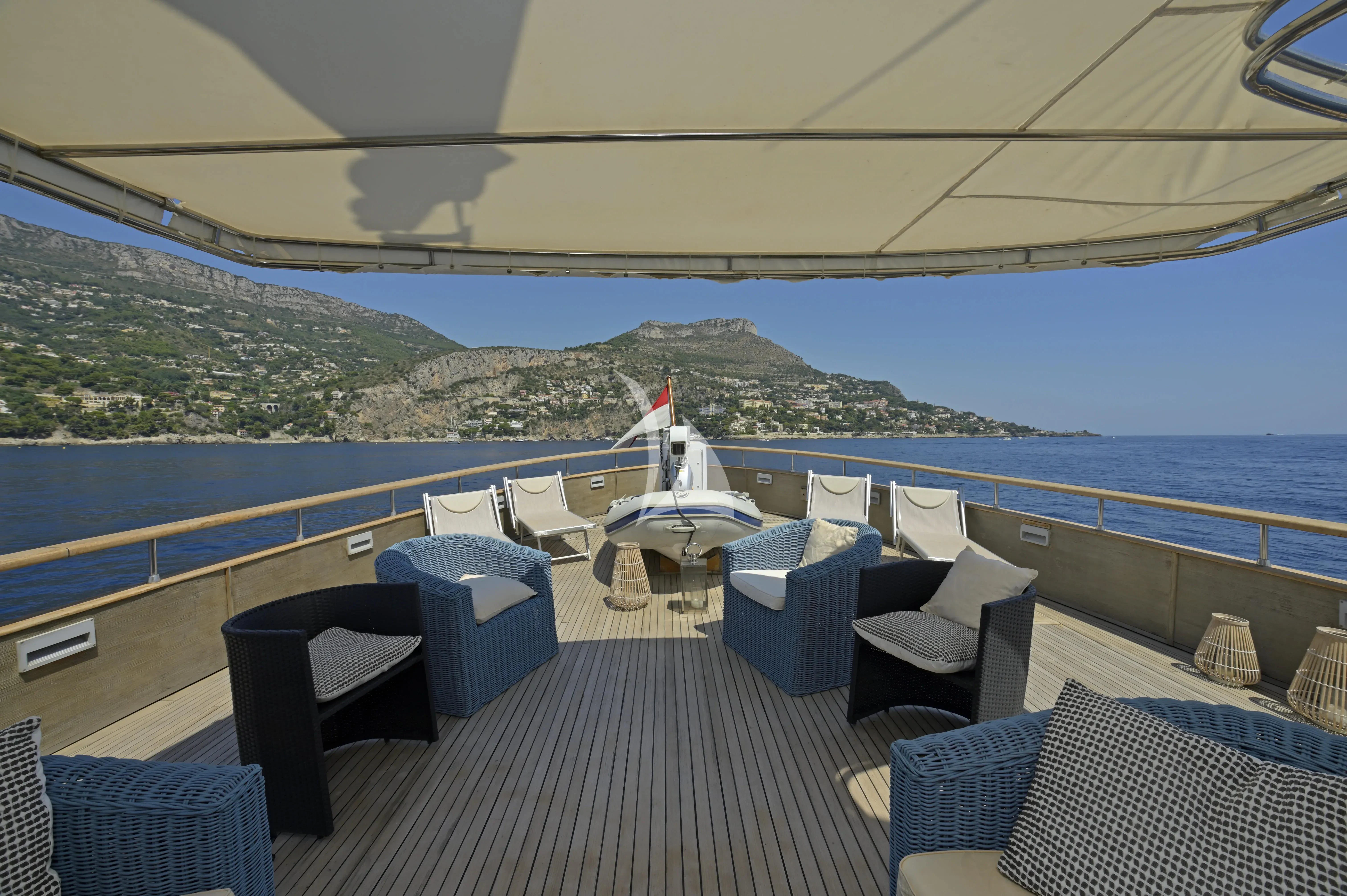 a deck with chairs and tables on it aboard LA VOGLIA MATTA Yacht for Charter