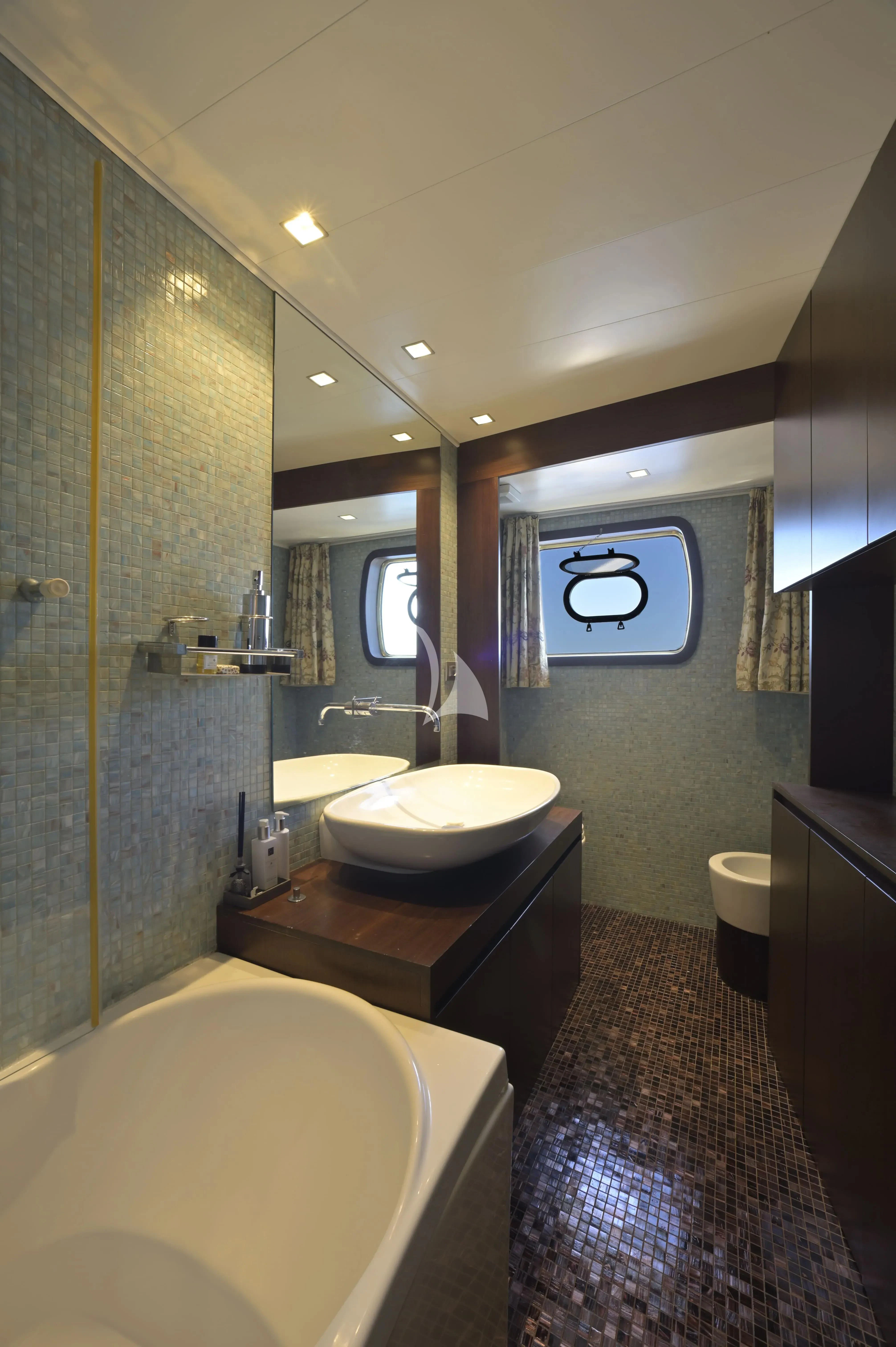 a bathroom with a sink and a bathtub aboard LA VOGLIA MATTA Yacht for Charter