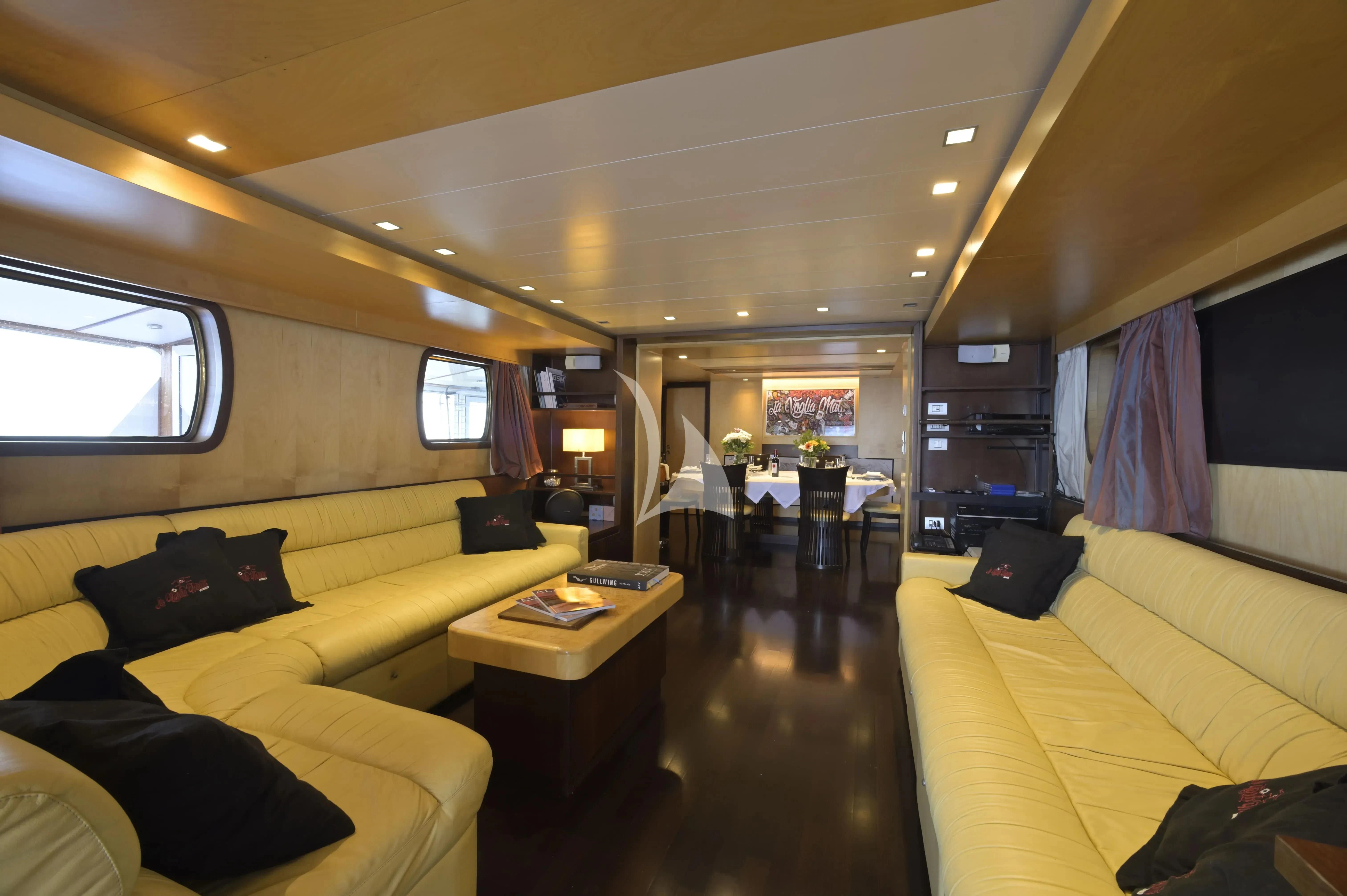 a train with a couch and coffee table aboard LA VOGLIA MATTA Yacht for Charter