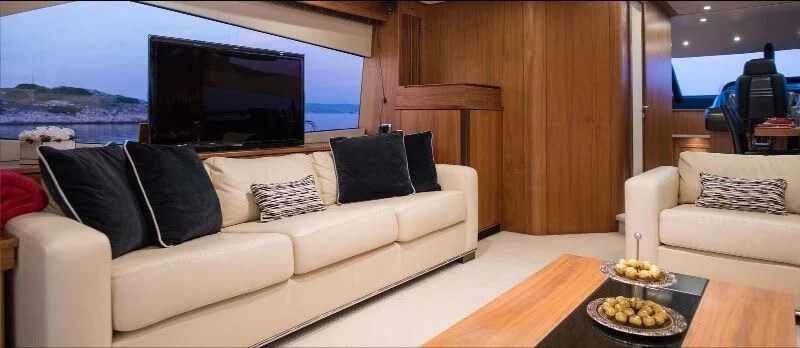a living room with a large window aboard SPIRIT OF THE SEA Yacht for Sale