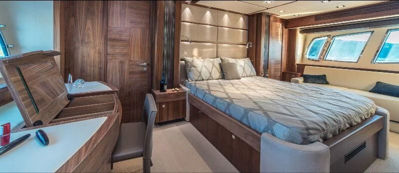 a room with a bed and a desk aboard SPIRIT OF THE SEA Yacht for Sale