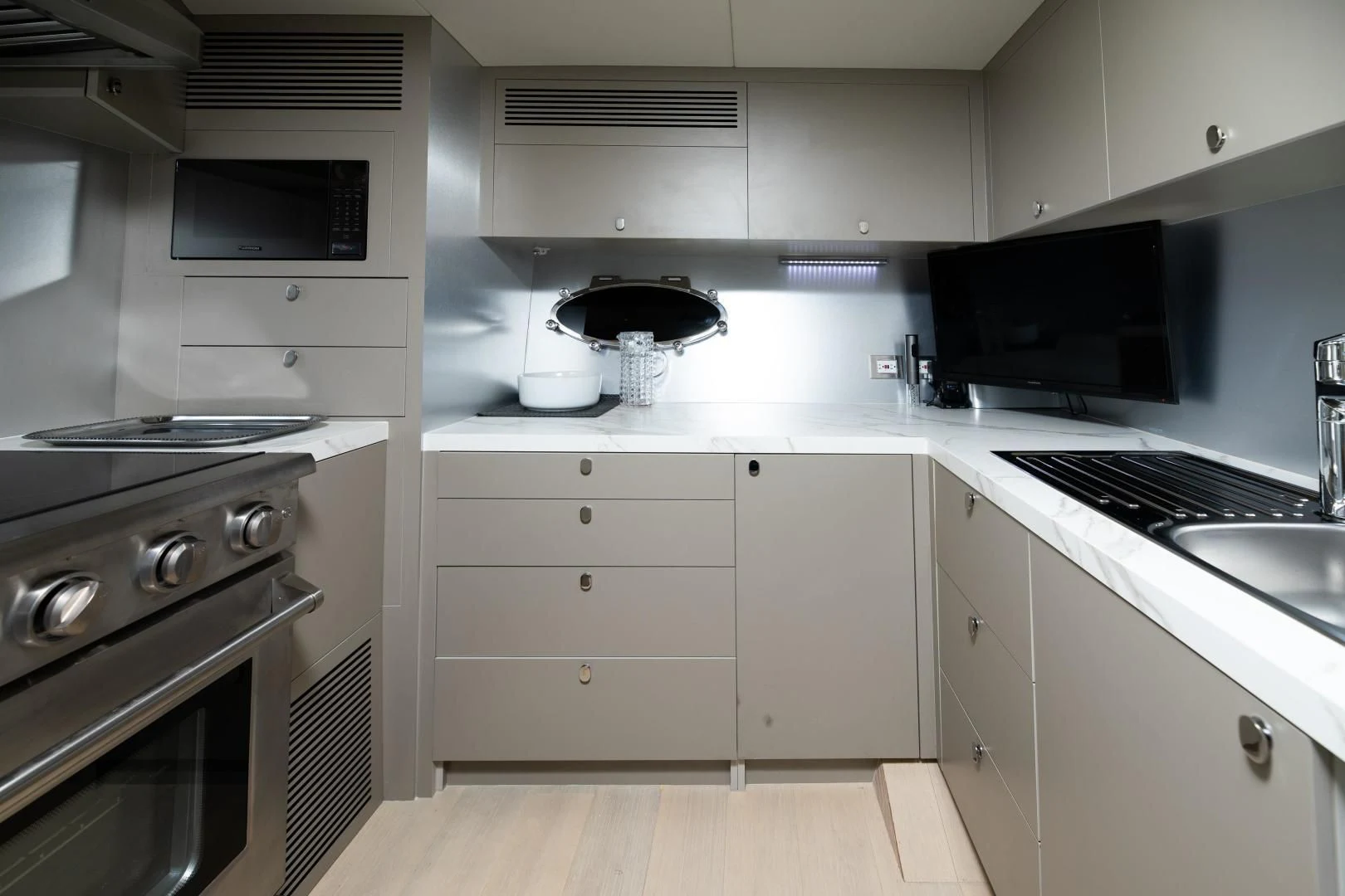 a kitchen with white cabinets aboard ADONIS Yacht for Sale