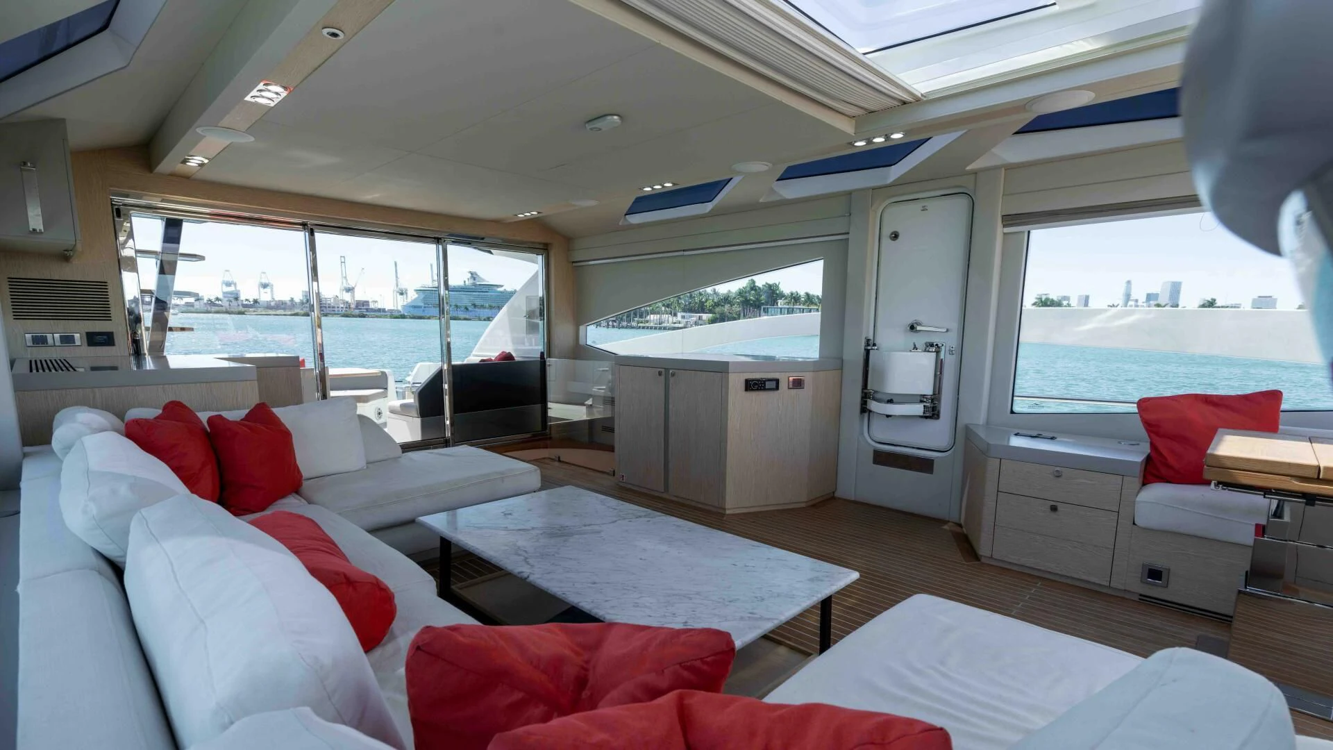 a room with a couch and a table and a window aboard ADONIS Yacht for Sale