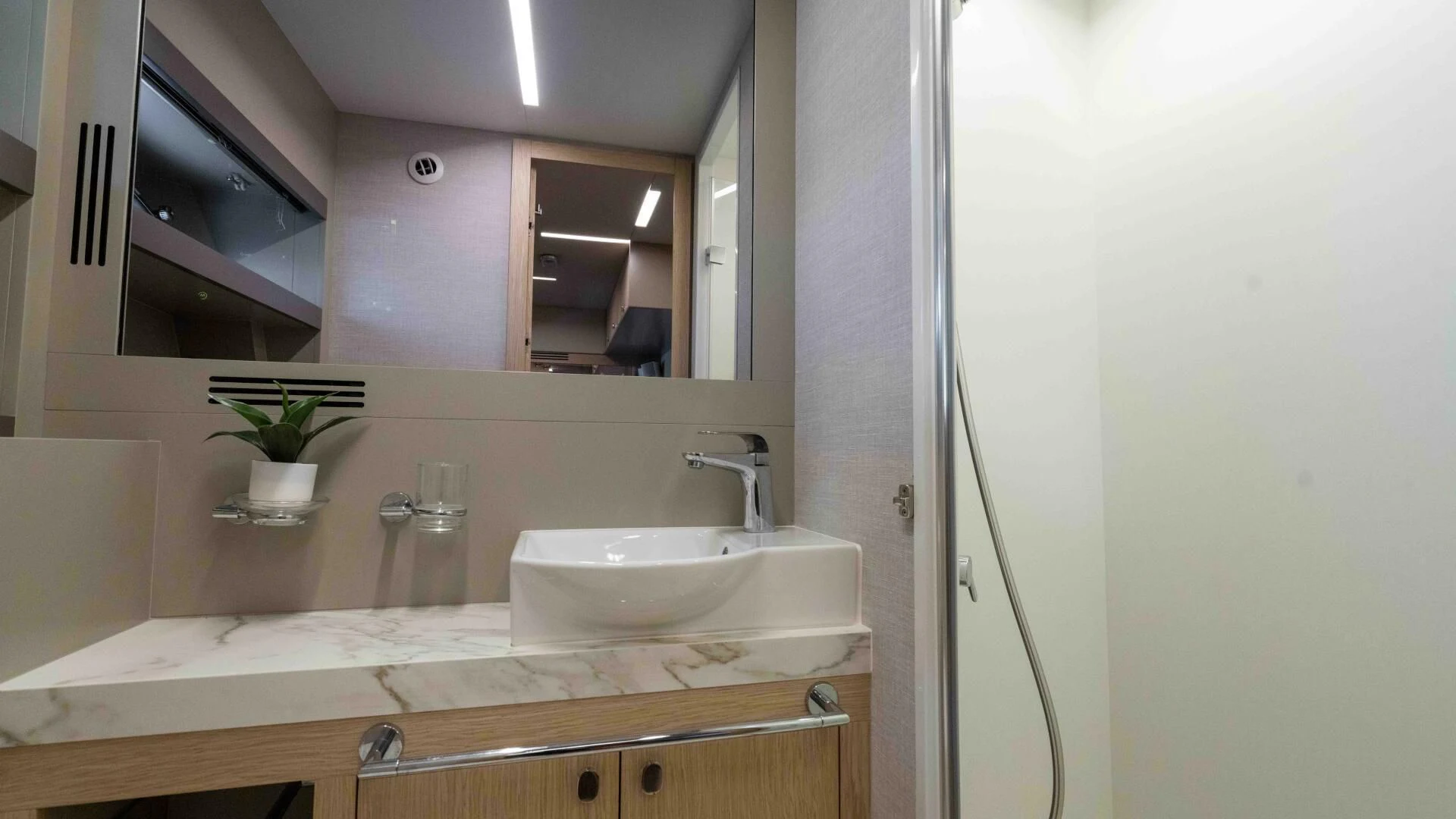 a bathroom with a large mirror aboard ADONIS Yacht for Sale