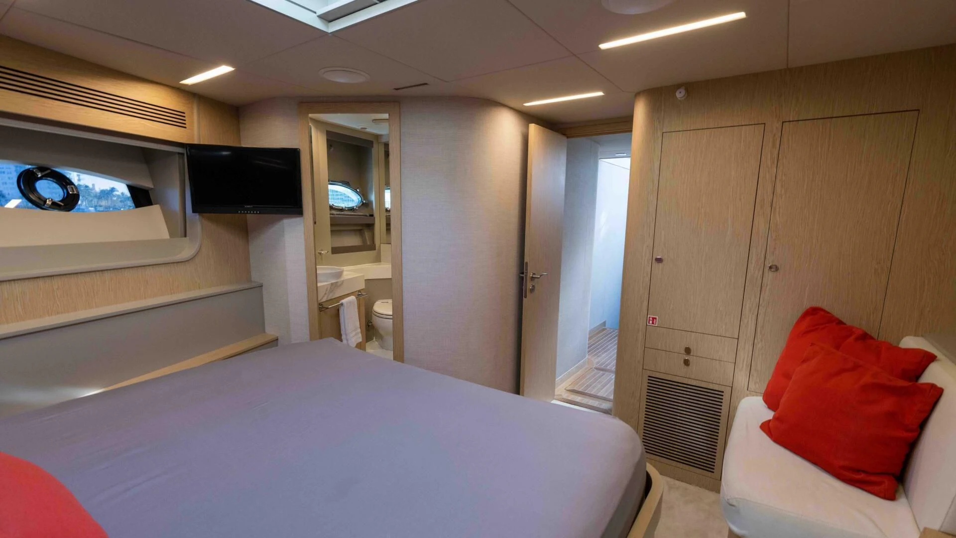 a room with a bed and a tv on the wall aboard ADONIS Yacht for Sale