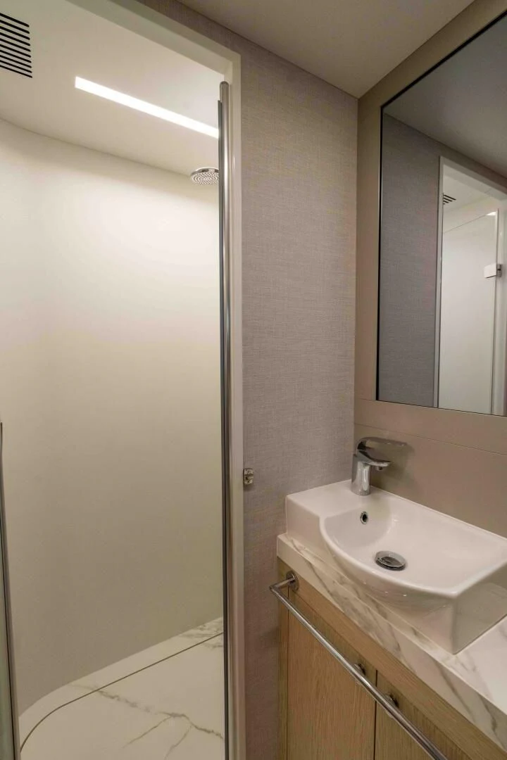 a bathroom with a sink and mirror aboard ADONIS Yacht for Sale