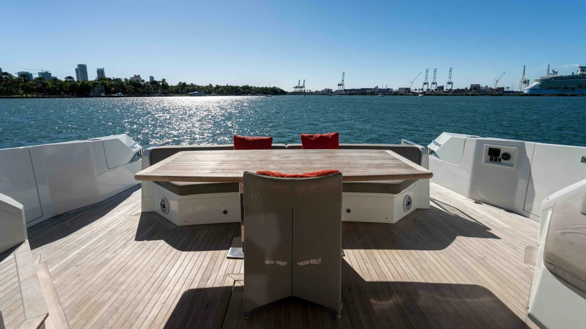 a table and chairs on a deck overlooking a body of water aboard ADONIS Yacht for Sale