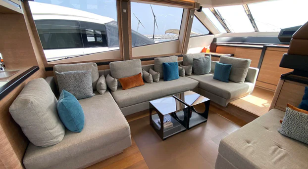 a living room with a couch and a table aboard CARPE DIEM Yacht for Charter