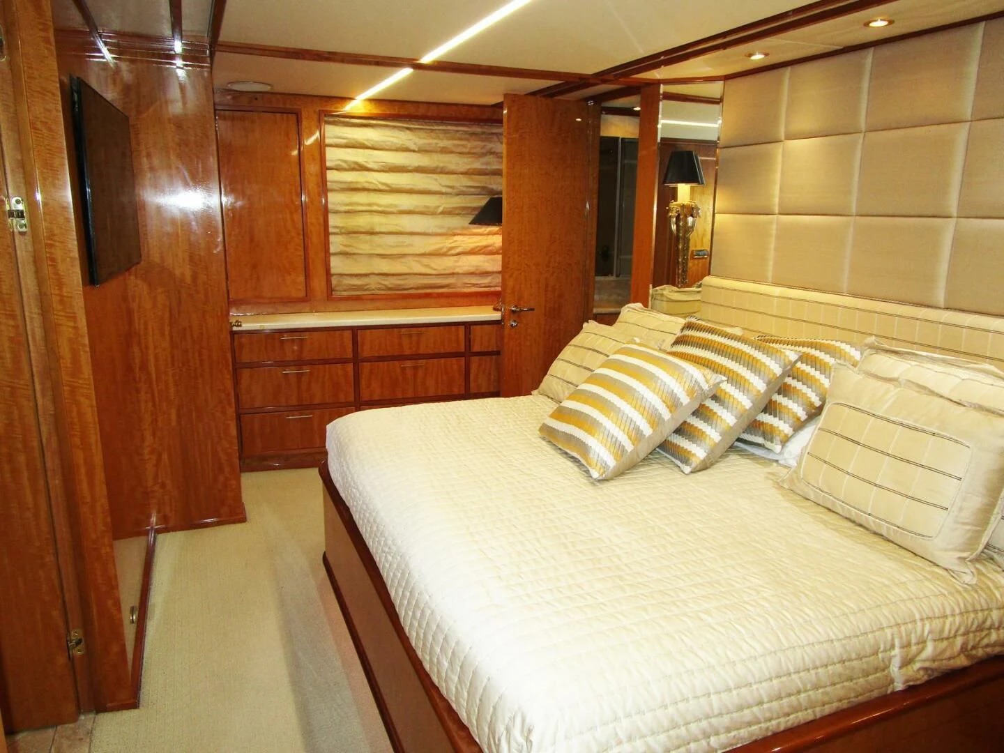 a room with a bed and wooden cabinets aboard CARPE DIEM Yacht for Charter
