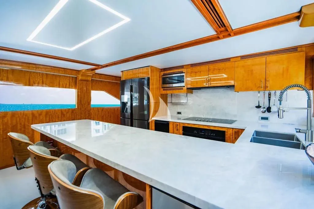a kitchen with a bar and chairs aboard CARPE DIEM Yacht for Charter