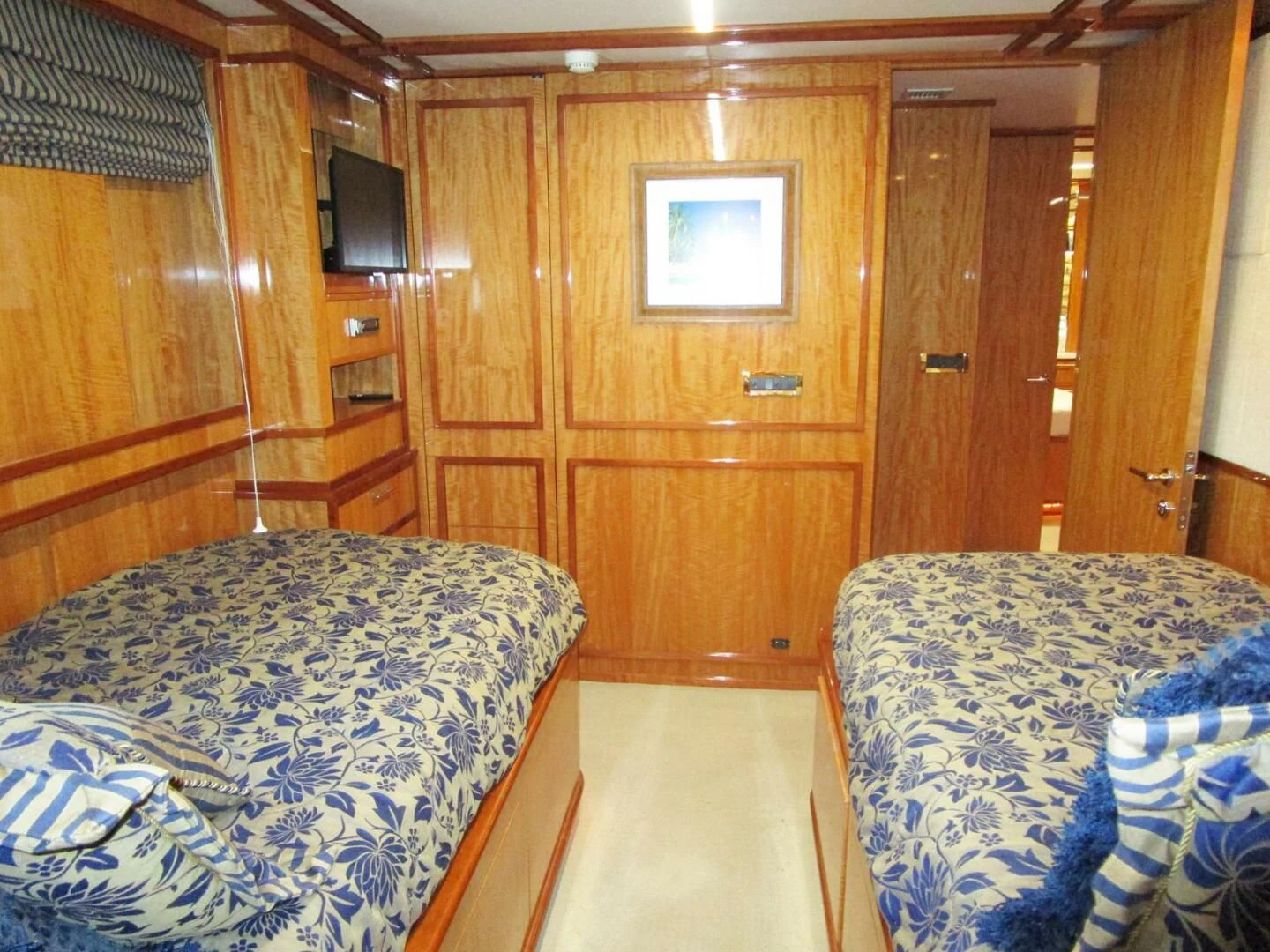 a room with a bed and a wood cabinet aboard CARPE DIEM Yacht for Charter